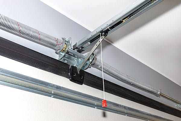 Springs tensioning the home garage door mechanism, visible disconnection of the electric drive and and spring protection