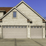 Three car wooden garage with driveway