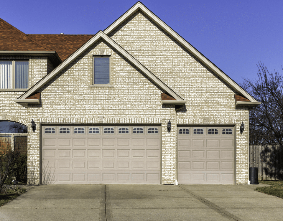 Three car wooden garage with driveway